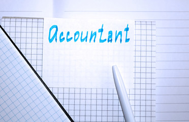 The word ACCOUNTANT is written by hand on the paper. Concept of accountant work