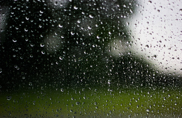 Raindrops on glass, raindrops on a transparent window. Drops of water on a black background. Drops of water on a glass surface as a background.