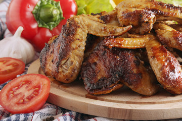 Chicken wings barbecue with different vegetables