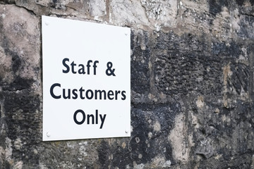 Staff and customer parking only sign in car park