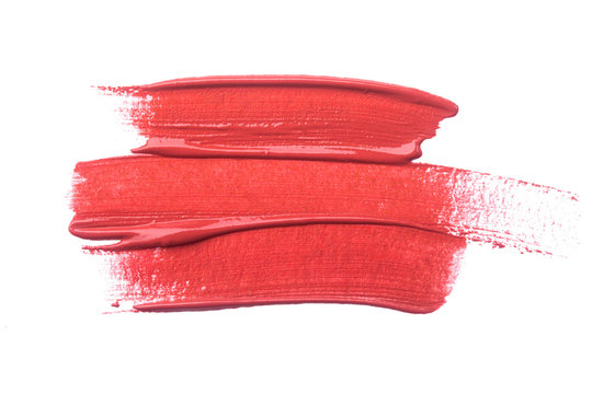 Lipstick smear isolated on white background. Red lip makeup product swatch.