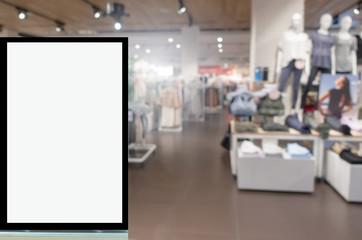 blank showcase billboard or advertising light box for your text message or media content with blurred image popular women fashion clothes shop showcase in shopping mall, commercial, marketing concept