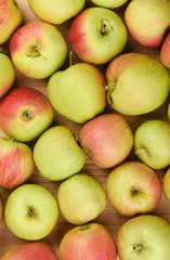 Drops of water on ripe apples. A lot of apples as a background.