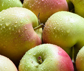 Macro shot. Drops of water on ripe apples.