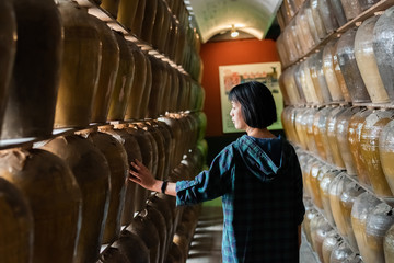 woman stand with old pottery