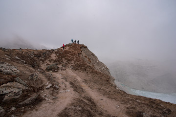Group of tourists in foggy mountains