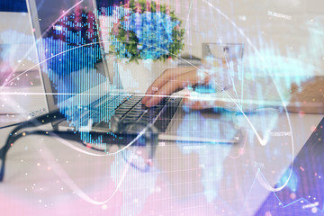 Obraz premium Double exposure of businessman working on laptop on background. International business hologram in front. Concept of success.