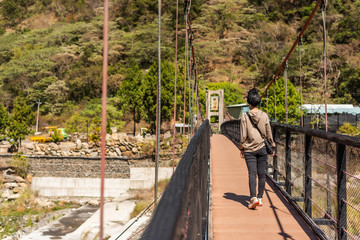 woman walk on a suspension bridge