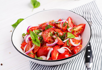 Tomato salad with basil and red onions. Homemade food.  Concept healthy meal. Vegan cuisine.