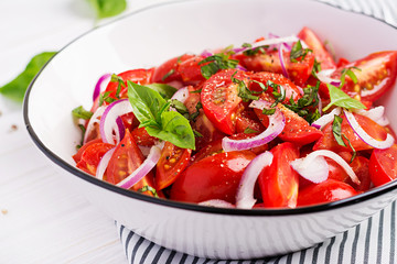 Tomato salad with basil and red onions. Homemade food.  Concept healthy meal. Vegan cuisine.