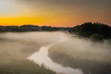 beautiful morning at Rogers Reservoir Conservation Area East Gwillimbury Ontario Canada with grasses, trees, fog, bridge, and river