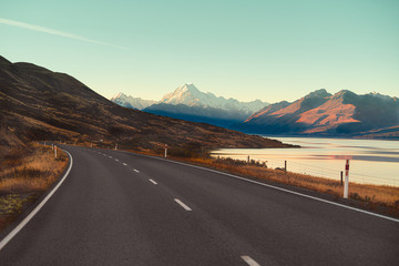 Scenic View of Mt Cook in New Zealand with soft blue sky, view from car windshield while driving along the road on ridges. Nature sightseeing view are popular for tourist for look around.