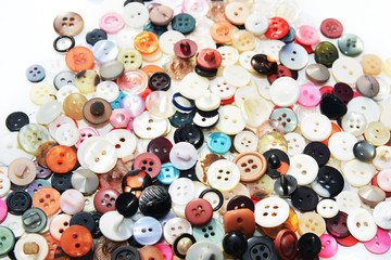 Multi-colored sewing buttons of different sizes and shapes on an isolated background 