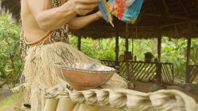 Indigenous Man Fixing Her Crown Of Feathers For Battle In Ecuador