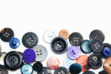 Multi-colored sewing buttons of different sizes and shapes on an isolated background 