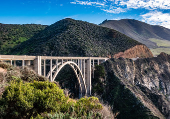 The Bixby Creek Bridge, or "Bixby Bridge" for short, was built along the Pacific Coast of the Monterey Bay in California, in Big Sur in 1932. California travel concept.