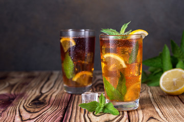 Glass of iced tea with mint and lemon. Cold drink. Rustic style