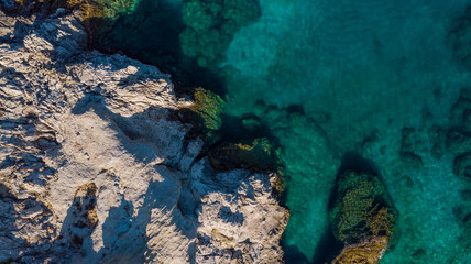 Turquoise Water and Rocky Shore on Greek Island, Aerial top Down View