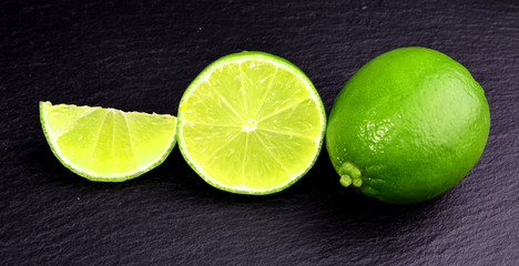 Fresh green lime and mint on black background