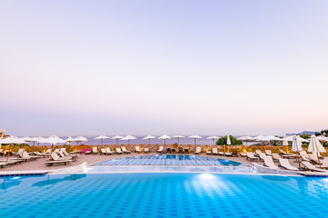Fototapeta na wymiar Luxury Swimming Pool at Sunrise in Hotel Resort, Rhodes, Greece