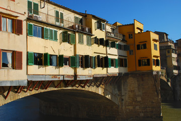 Fototapeta na wymiar The famous Ponte Vecchio bridge in Florence, Italy, lined with houses and shops