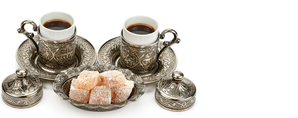 Obraz na płótnie Canvas Cups of coffee and turkish delight isolated on white background. Free space for text. Wide photo.