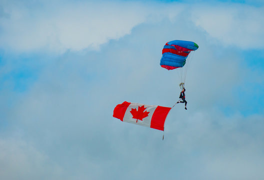 parachutist with Canadian flag - Powered by Adobe