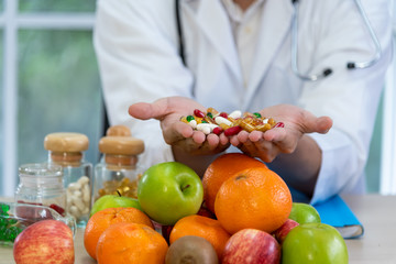 Blurred soft images of male nutritionists are presenting fresh food and fruit extracts To be and...