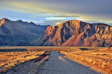 Naklejka premium The gravel road between the endless pampas