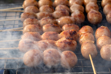 Grilled Thai sausage at street food market in Thailand. Traditional Thai sausage with pork and rice, delicious street food.