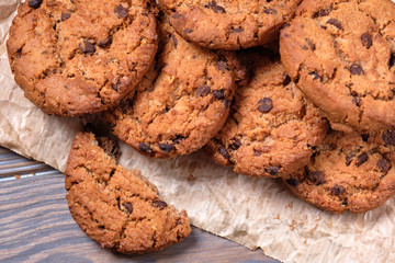 Chocolate oatmeal chip cookies on the rustic wooden table.