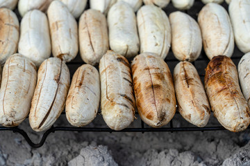 Grilled Thai banana at street food market in Thailand. Fried banana, delicious street food.