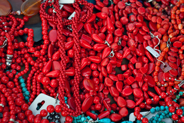 Necklace of colorful stones on the table. Many different jewelry and beads made of natural precious minerals. Turquoise jewelry is on sale at the fair.