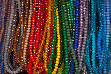Necklace of colorful stones on the table. Many different jewelry and beads made of natural precious minerals. Jewelry is sold at the fair.