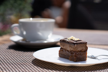 Raw vegan cake on the white plate. Healthy desserts, close up