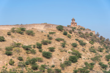 The long wall on the mountain of Amber fort in historical city of Amer, Jaipur, Rajasthan, India
