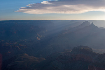 Fototapeta premium Sun rays at sunrise from Mather Point on South Rim of Grand Canyon National Park, Arizona in summer.
