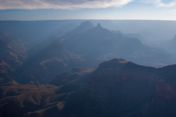 Sun rays at sunrise from Mather Point on South Rim of Grand Canyon National Park, Arizona in summer.