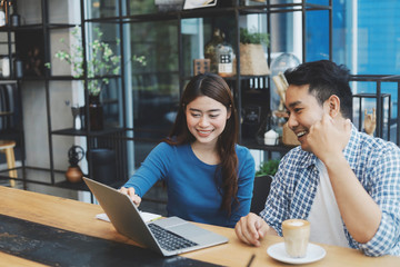 Two Asian people working together.