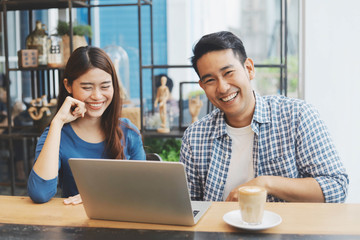 Two Asian people working together.