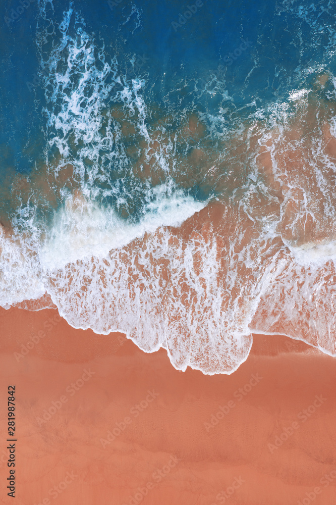 Wall mural aerial view of pink beach and blue ocean wave.