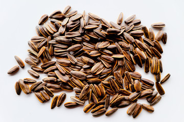Abstract close up sunflower seeds on the white isolated background and wallpaper