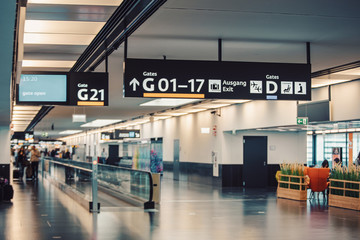 Peoples walking and carries luggage in Vienna airport terminal