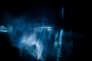 Lens Flare. Light over black background. Easy to add overlay or screen filter over photos. Abstract sun burst with digital lens flare background. Gleams rounded and hexagonal shapes, rainbow halo.