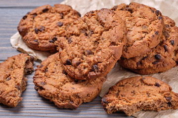Chocolate oatmeal chip cookies on the rustic wooden table.