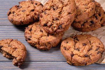 Chocolate oatmeal chip cookies on the rustic wooden table.