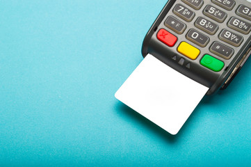 Credit card terminal on blue background. Close up of merchant  payment device, card machine.