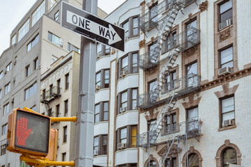 One way sign and old apartment facades, with fire stairs. Soho, Manhattan. NYC