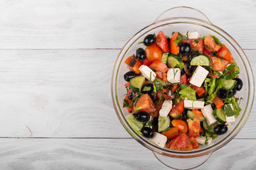 Fresh Greek salad in a glass bowl