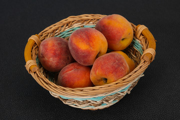 Peach heap in the wooden basket